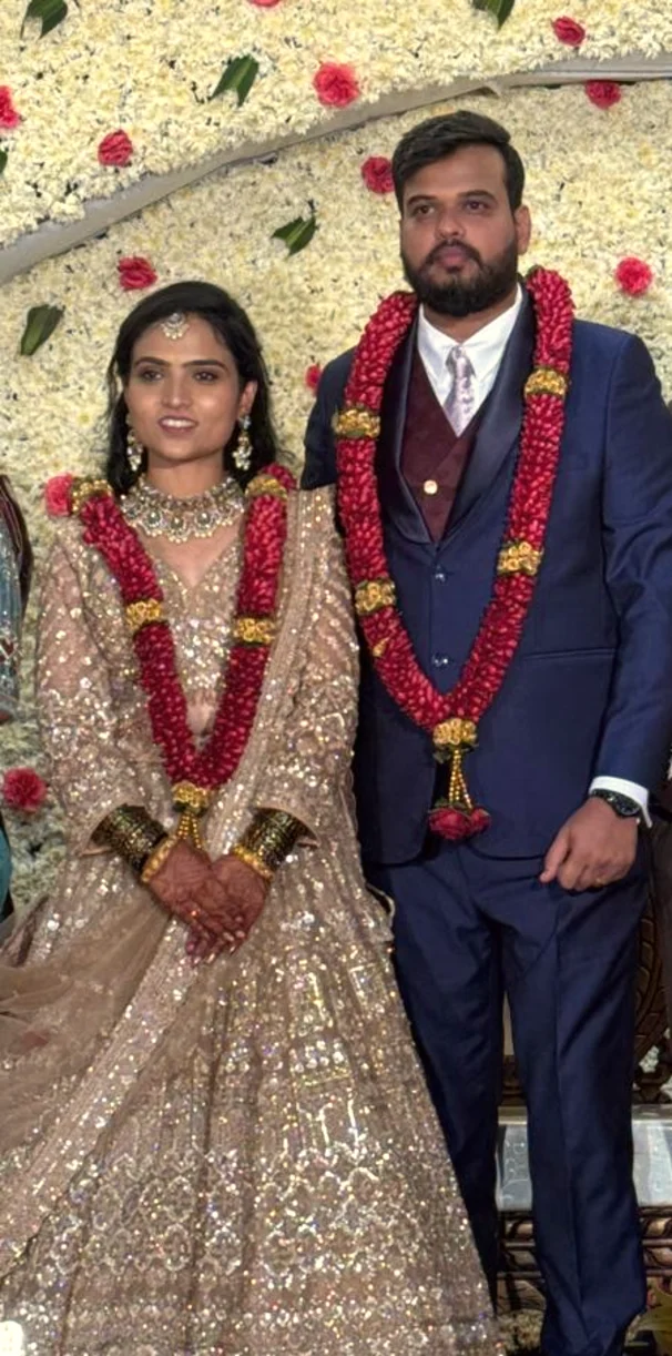 Bride and groom in ivory and gold with rose garlands, Anubhandhaa Bangalore